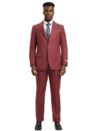 A man wearing a M & R Clothing Stacy Adams 3-piece sharkskin suit in deep red with a white shirt and grey tie.