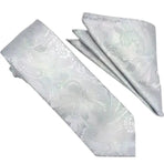 A matching necktie and pocket square set in a light silver-gray color with a subtle woven paisley pattern, displayed on a clean white background.