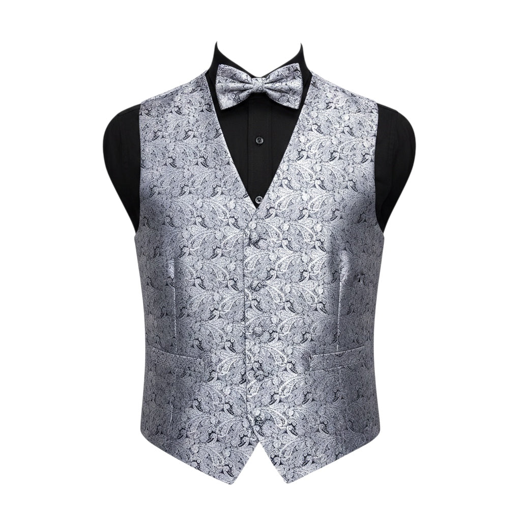 A men's formal vest with a matching bow tie, displayed on a black mannequin torso against a plain white background. The vest and bow tie feature an intricate silver and gray damask pattern, while the shirt underneath is solid black.