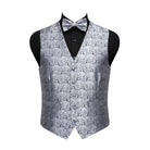 A men's formal vest with a matching bow tie, displayed on a black mannequin torso against a plain white background. The vest and bow tie feature an intricate silver and gray damask pattern, while the shirt underneath is solid black.