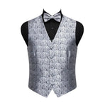 A men's formal vest with a matching bow tie, displayed on a black mannequin torso against a plain white background. The vest and bow tie feature an intricate silver and gray damask pattern, while the shirt underneath is solid black.